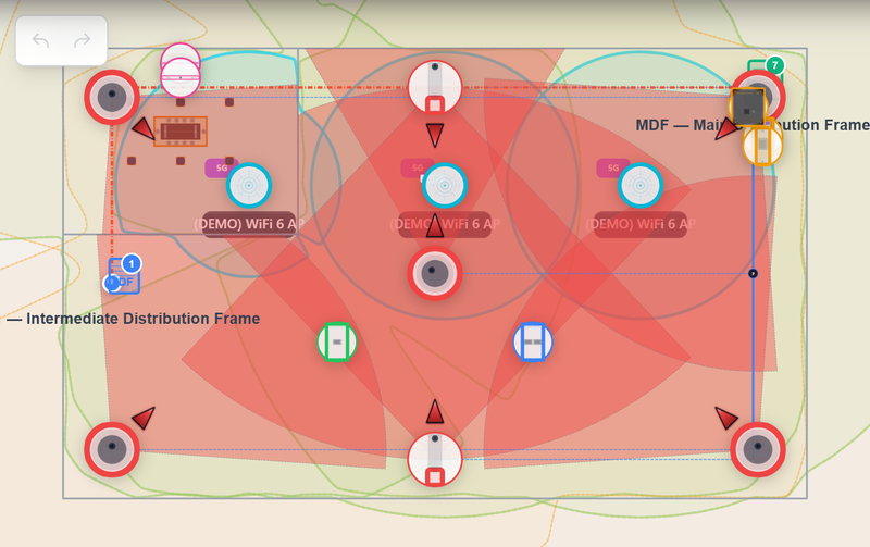 SiteOps Command design surface: a warehouse floor plan with placed security cameras, their field-of-view cones, and a computed camera-coverage heatmap across MDF and IDF zones.